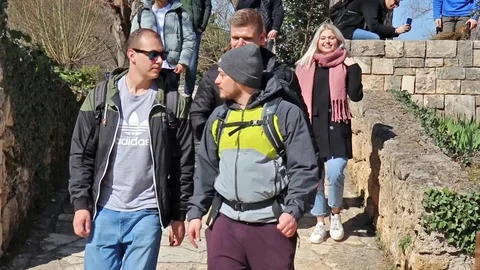 A group of students walking by the camera, gesturing towards the camera no ph Stock Footage 126208783