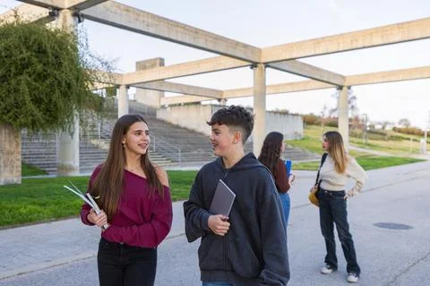 Group of students walking on campus talking Stock Photos