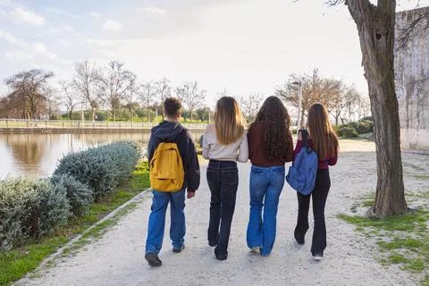 Group of students walking together on campus path Stock Photos