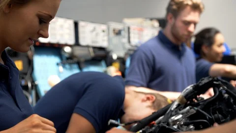 Group Of Students Working On Car Engines In College Class Stock Footage 86601134