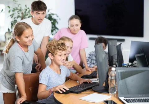 Group of students working at computer in classroom Stock Photos