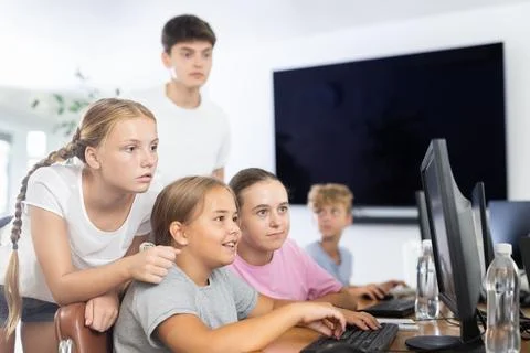 Group of students working at computer in classroom Stock Photos