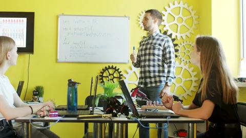 Group of students working together in classroom with laptops Stock Footage 140763874