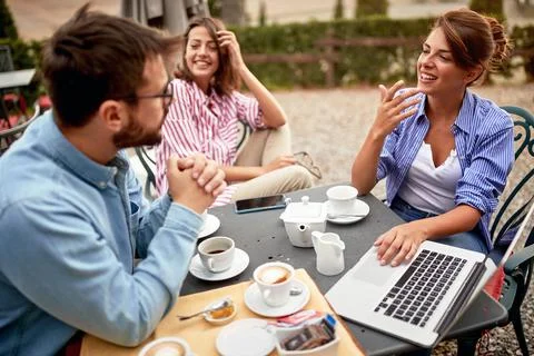 Group of students writing paper while drinking coffee Stock Photos