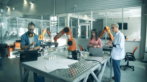 Group of students, young engineers testing robot. Laboratory with researchers Stock Footage 127629518