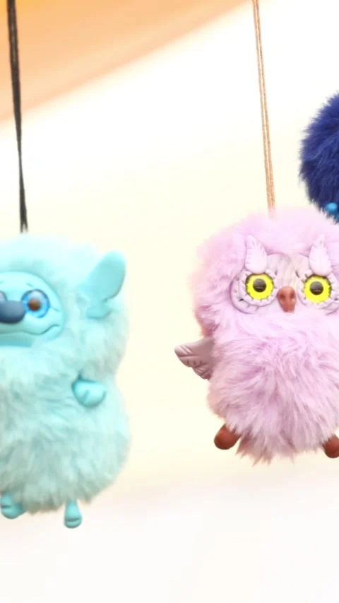 A group of stuffed animals hanging from strings, great for decoration or il.. 库存影片 344157557