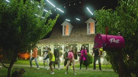 Group stylish dancers dancing on yard at night . Kids dancing with house workers Stock Footage 233182609