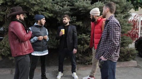 Group of stylish young men communicates standing in park Stock Footage 285398182
