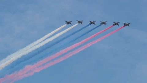 The group of Su-25 combat jets releases smoke in the colors of the Russian flag  Stock Footage 191961842