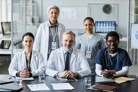 Group of successful professional clinicians in lab coats and uniform Stock Photos