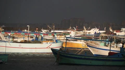 A Group of Sunlit Boats on a Dark Background of the Sky and the City Stock Footage 243077172