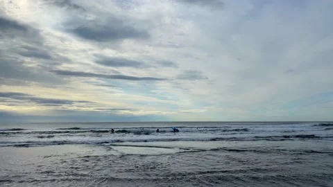 Group of surfers are learning to ride the small waves of the Pacific Ocean Video stock 141247016