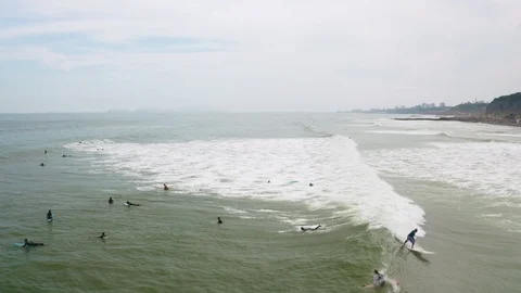 Group of surfers catching waves at Makaha beach in Miraflores with surfboards Stock Footage 108465321