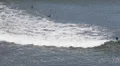 Group of Surfers enter to Surfing in the Ocean, Waves Crashing, Jagged Rocks HD Footage