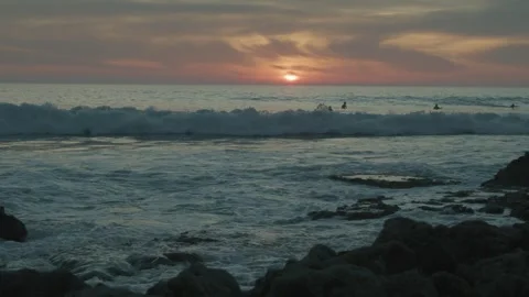 A Group Of Surfers On The Ocean During Sunset Stock Footage 273498661