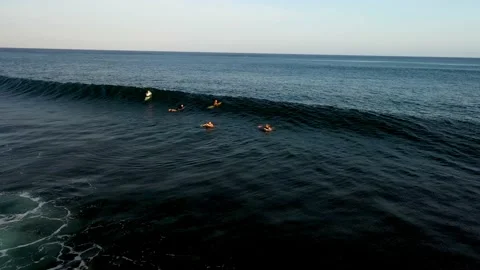 A group of surfers in ocean waiting for waves to ride. Surfing on Bali. Stock Footage 135482681