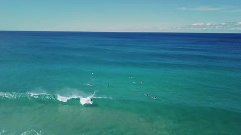 A group of surfers paddling over a large wave at Gold Coast. Concept beauty and Stock Footage 294636699