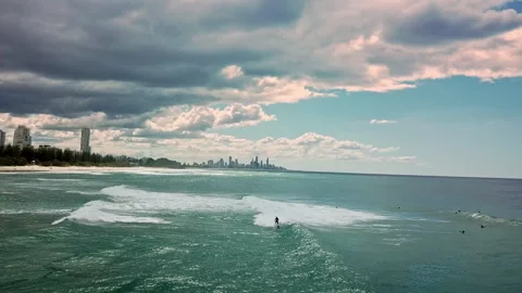 A group of surfers paddling over a large wave at Gold Coast. Concept beauty and Video stock 294636731
