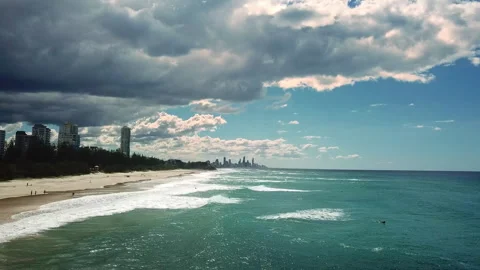 A group of surfers paddling over a large wave at Gold Coast. Concept beauty and Stock Footage 294637059