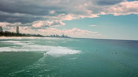 A group of surfers paddling over a large wave at Gold Coast. Concept beauty and Video stock 294637284