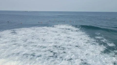 Group of surfers waiting in the pacific ocean during the daytime Stock Footage 155080921