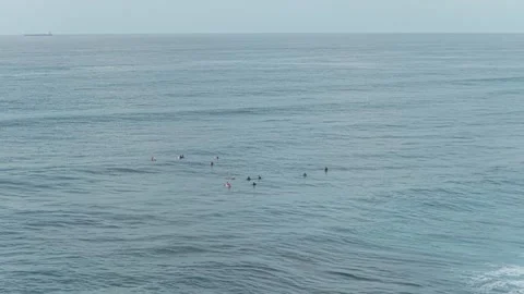 Group of surfers waiting for waves in the open ocean Stock Footage 328923205