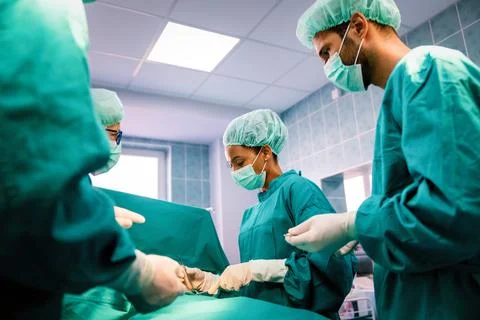 Group of surgeon team at work in operating room in hospital Stock Photos
