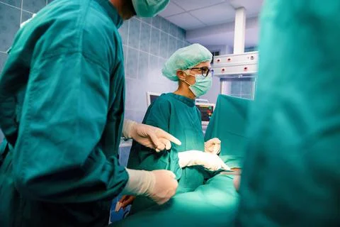 Group of surgeon at work in operating room in hospital Stock Photos