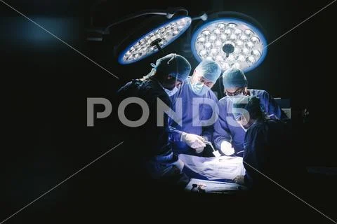 Group of surgeons in hospital operating theater Stock Photos