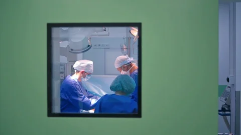 Group of surgeons performing an operation. Doctors in blue medical uniform Stock Footage 125895034