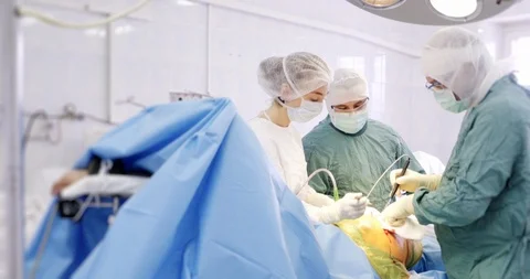 A group of surgeons performing an operation in operating theatre. Medicine Stock-Footage 121094878