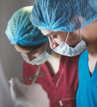 Group of surgeons at work operating in surgical theatre. Resuscitation medicine Stock Photos