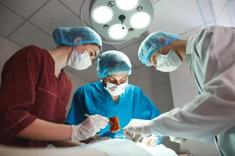 Group of surgeons at work operating in surgical theatre. Resuscitation medicine 스톡 사진