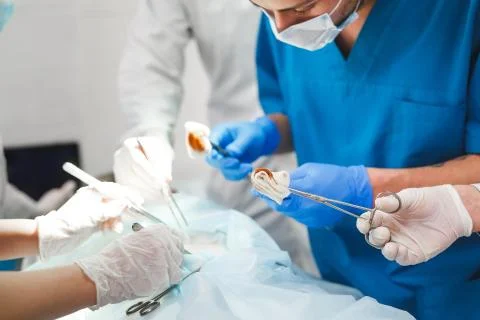 Group of surgeons at work operating in surgical theatre. Resuscitation medicine Stock Photos