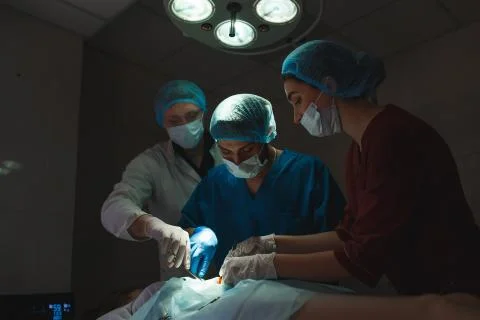 Group of surgeons at work operating in surgical theatre. Resuscitation medicine 스톡 사진