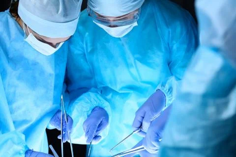 Group of surgeons at work while operating at hospital. Health care and 库存照片