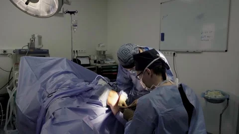 A group of surgeons works in the operating room. Stockbeeldmateriaal 269435784