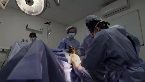 A group of surgeons works in the operating room. Stockbeeldmateriaal 269436142