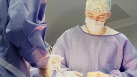 A group of surgeons works in the operating room. Stockbeeldmateriaal 269440047