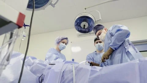 A group of surgeons works in the operating room. Stockbeeldmateriaal 269481072