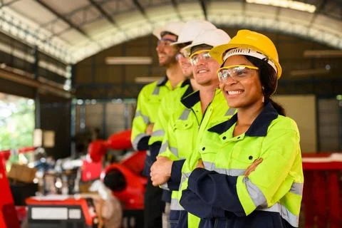 Group of technicians engineers workers posing to camera with smile Stock Photos