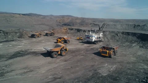 Group of technological transport around huge mining excavator. Aerial view dump Stock Footage 203918411