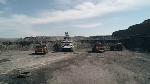 Group of technological transport around huge mining excavator. Two dump trucks Stock Footage 203918602