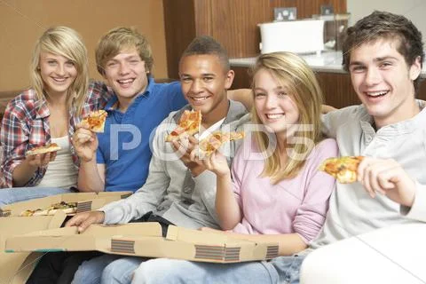 Group Of Teenage Friends Sitting On Sofa At Home Eating Pizza Stock Photos