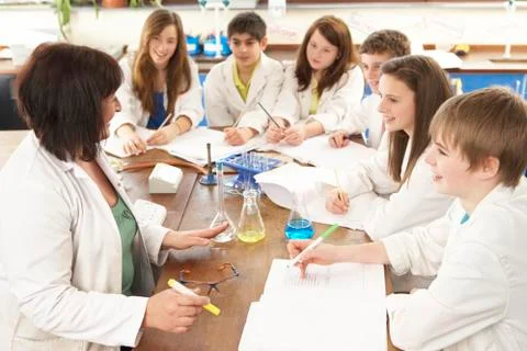 Group Of Teenage Students In Science Class With Tutor Stock Photos