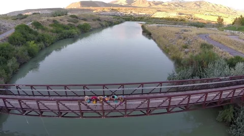 Group Of Teens Look Down At River From Bridge, Drone Flies Over Them Stock-Footage 47494682