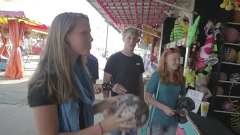 Group of teens playing games at amusement park together Stock Footage 75687700