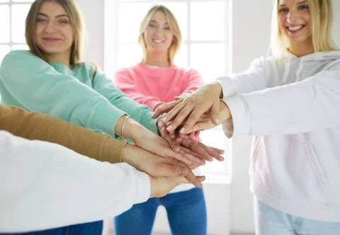 Group of teens stacking their hands, unity and solidarity Stock-Fotos