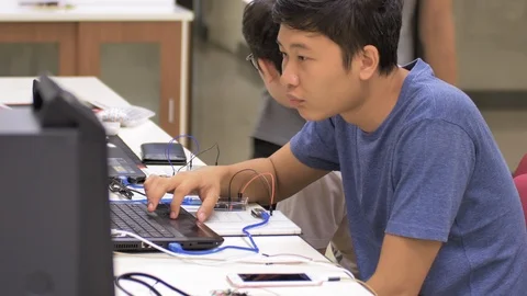 Group of Thai programmers sitting in front of the laptop and working in Stock Footage 115508960