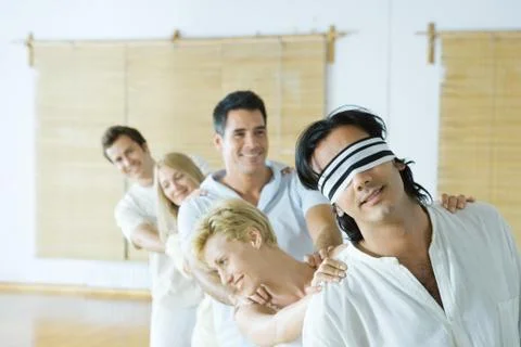 Group therapy, standing in single file line with hands on each other's shoulders Stock Photos